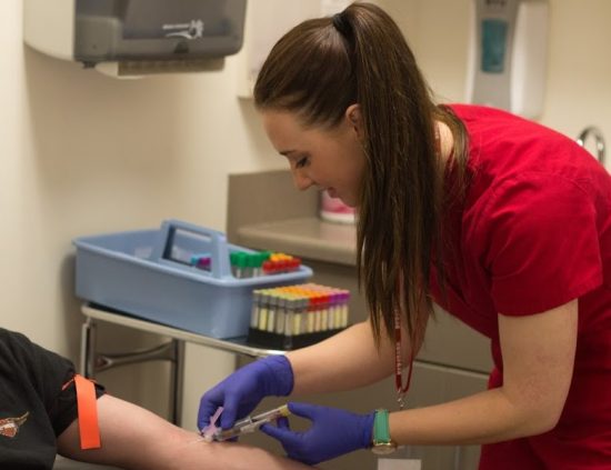 Phlebotomist doing blood draw in a laboratory draw site in one of our Boise, Garden City, Meridian, Idaho Falls, Pocatello and Rexburg locations.